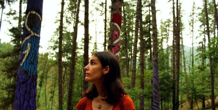 Woman between painted trees