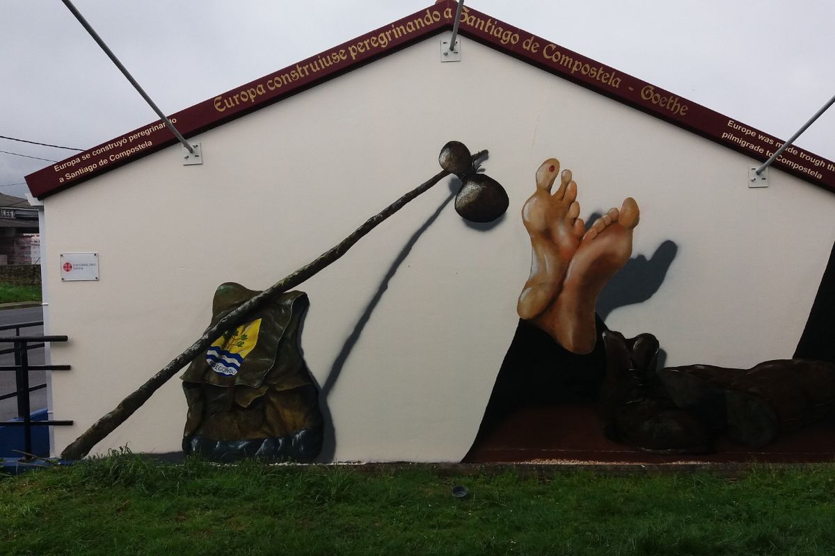 Mural of a walking pilgrim resting on the English Way from Ferrol