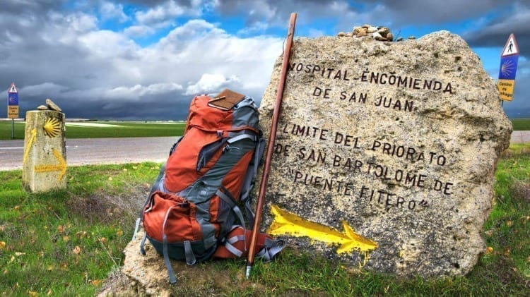 A backpack beside the sign of Hospital de San Juan