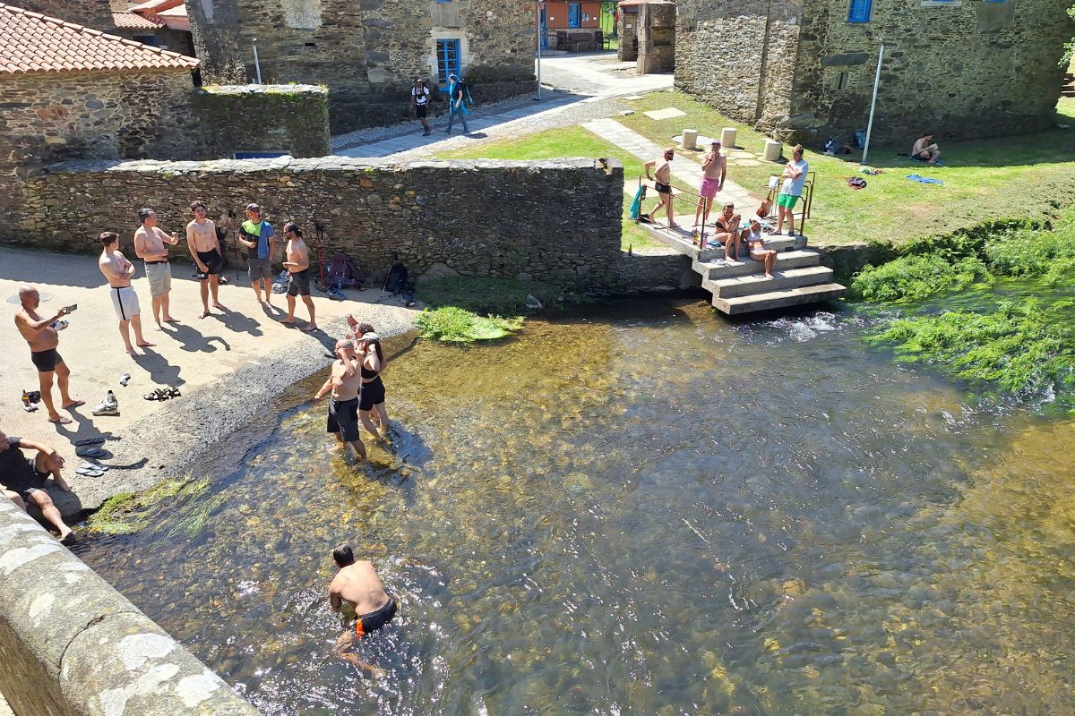 Pilgrims having a bath in the Iso river, on the French Way